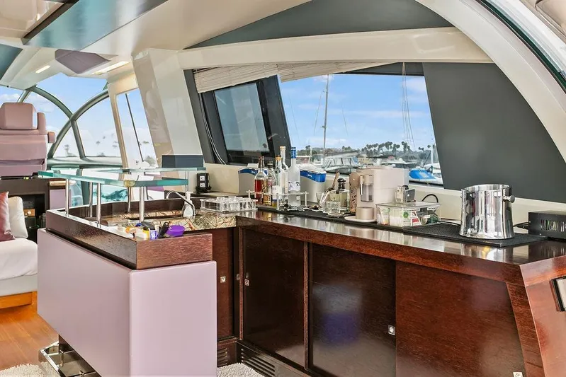 Argonaut Yacht Photos Pics Luxurious interior of 2011 Baia yacht with elegant bar setup and scenic marina view.