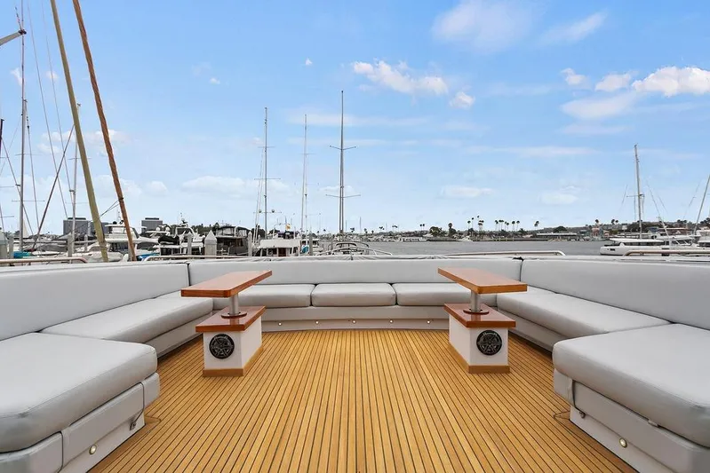 Argonaut Yacht Photos Pics Spacious deck of 2011 Baia yacht with elegant seating and tables, overlooking marina.