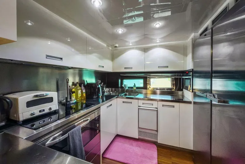 Argonaut Yacht Photos Pics Modern yacht kitchen with stainless steel appliances, white cabinets, and pink rug, Baia xxx 2011.
