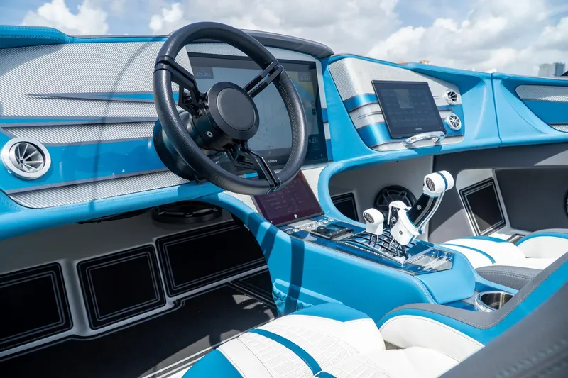  Yacht Photos Pics 2024 MTI 440X boat interior with modern dashboard and steering wheel, featuring blue and white design.