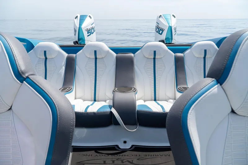  Yacht Photos Pics 2024 MTI 440X boat interior with blue and white seating, ocean backdrop.
