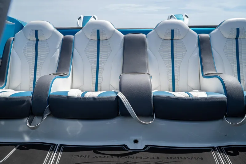  Yacht Photos Pics Luxurious 2024 MTI 440X boat interior with stylish white and blue seating.