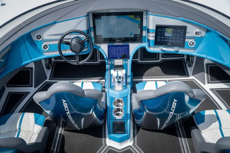  Yacht Photos Pics 2024 MTI 440X boat cockpit with advanced navigation screens and blue seating.