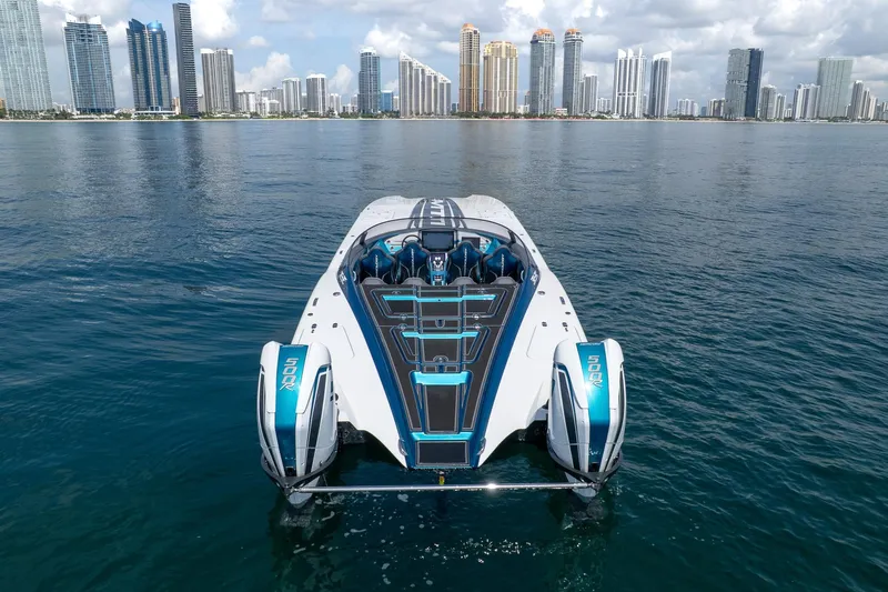  Yacht Photos Pics 2024 MTI 440X powerboat on water with city skyline in background.