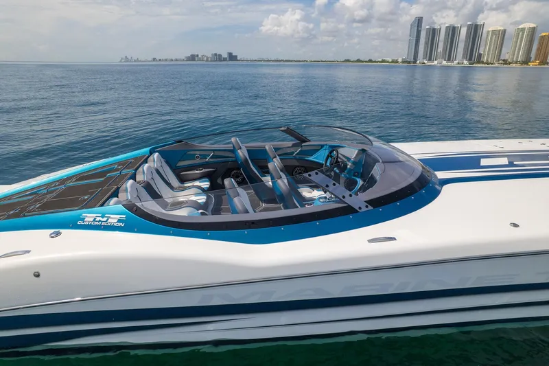  Yacht Photos Pics 2024 MTI 440X speedboat on water, city skyline in background.