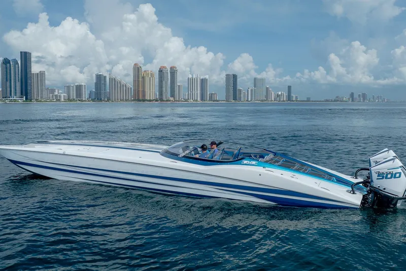  Yacht Photos Pics 2024 MTI 440X speedboat on water with city skyline in background.