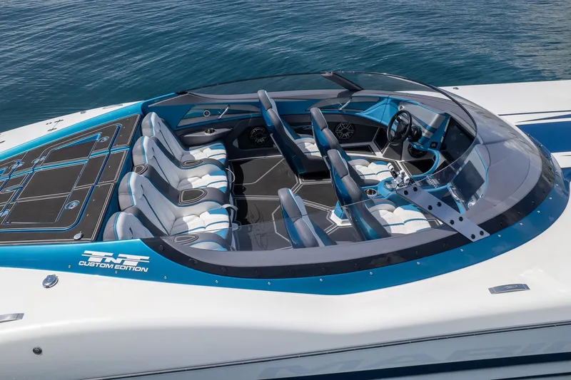  Yacht Photos Pics 2024 MTI 440X boat interior with sleek design, blue accents, and custom seating on water.