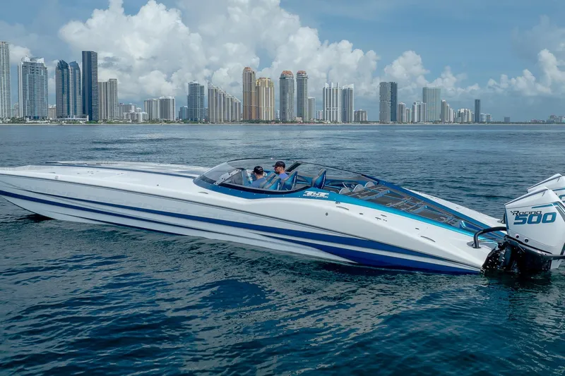  Yacht Photos Pics 2024 MTI 440X powerboat cruising near city skyline on a sunny day.