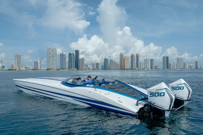  Yacht Photos Pics 2024 MTI 440X speedboat on water with city skyline in background.