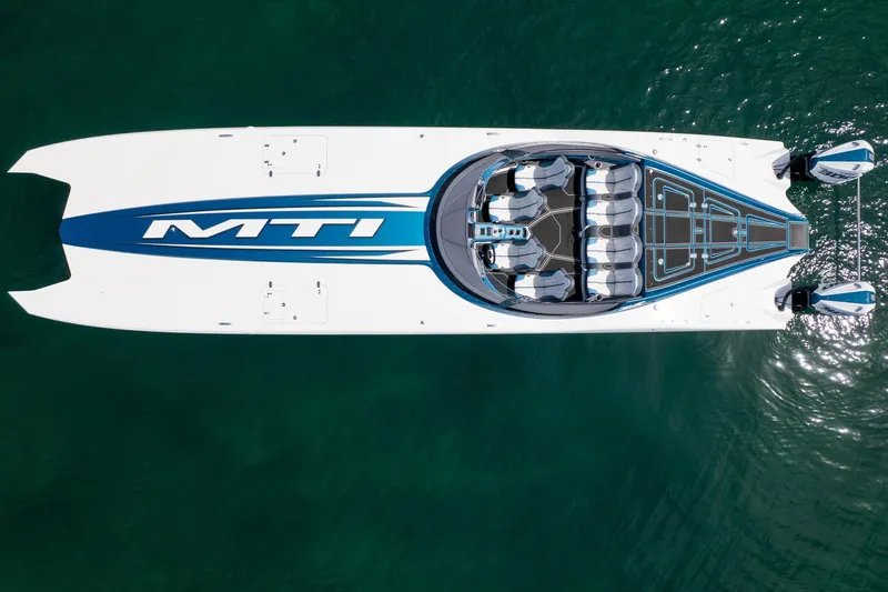  Yacht Photos Pics 2024 MTI 440X powerboat, aerial view, sleek design on clear water.