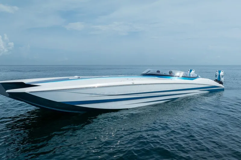  Yacht Photos Pics 2024 MTI 440X speedboat on calm ocean waters, showcasing sleek design and powerful engines.