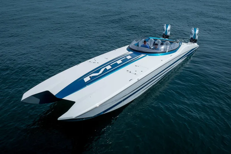  Yacht Photos Pics 2024 MTI 440X powerboat cruising on open water, showcasing sleek design and dual engines.