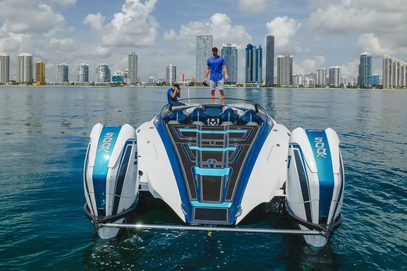  Yacht Photos Pics 2024 MTI 440X powerboat with twin Mercury 500R engines on a calm urban waterfront.