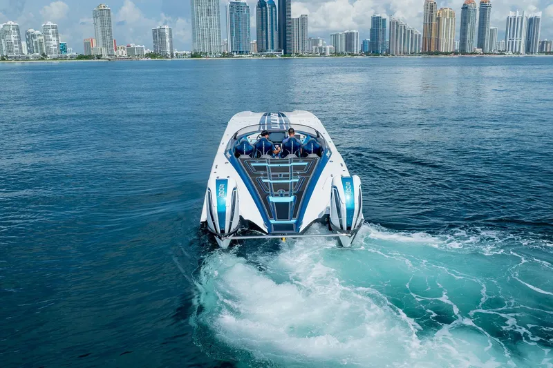  Yacht Photos Pics 2024 MTI 440X powerboat cruising in a city waterfront, skyscrapers in the background.