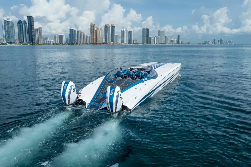  Yacht Photos Pics 2024 MTI 440X powerboat cruising near city skyline on a clear day.