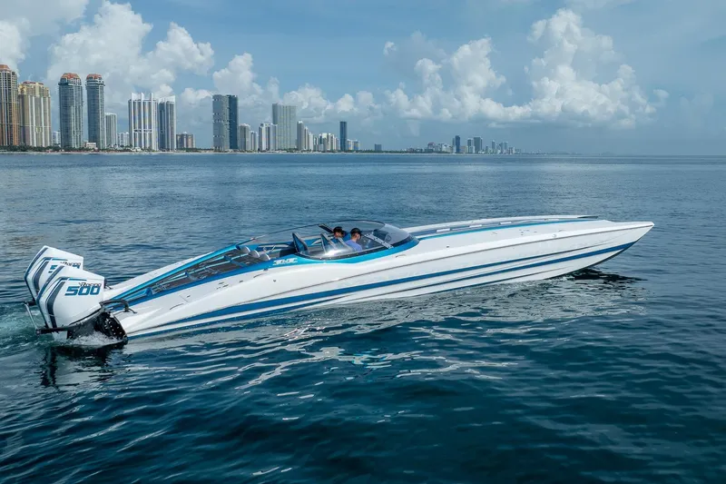  Yacht Photos Pics 2024 MTI 440X powerboat cruising near city skyline on a sunny day.