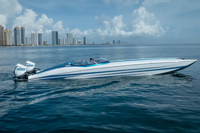  Yacht Photos Pics 2024 MTI 440X speedboat on calm water with city skyline in background.