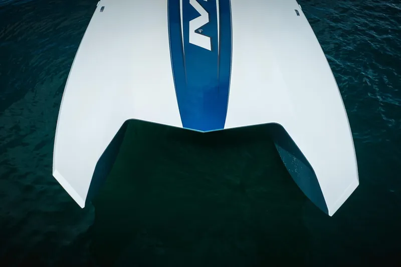  Yacht Photos Pics 2024 MTI 440X boat, sleek white and blue design, floating on water.