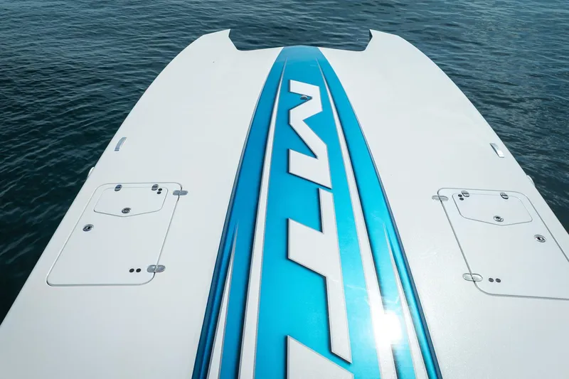  Yacht Photos Pics MTI 440X 2024 boat deck with blue accents on water.
