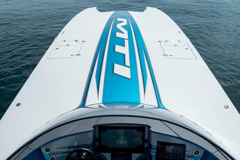  Yacht Photos Pics 2024 MTI 440X boat on water, showcasing sleek design and advanced dashboard.