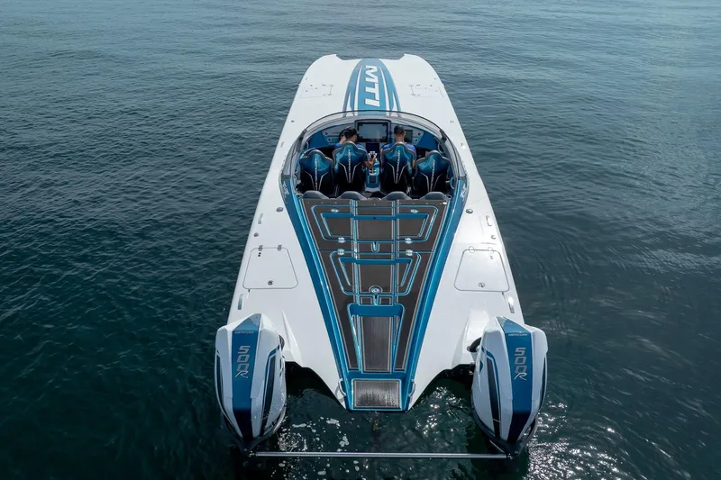  Yacht Photos Pics 2024 MTI 440X powerboat on water, featuring sleek design and dual Mercury 500R engines.