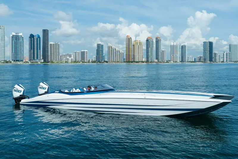  Yacht Photos Pics 2024 MTI 440X powerboat cruising on water with city skyline backdrop.