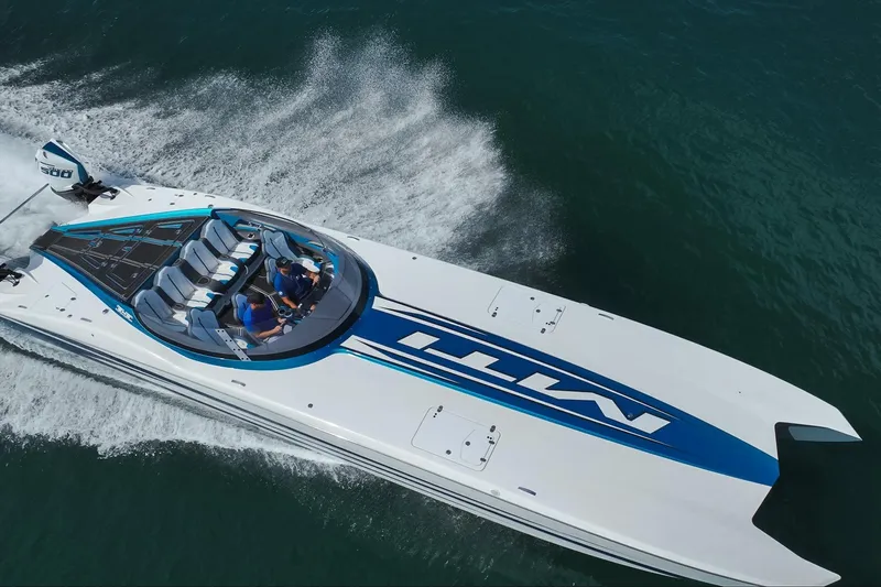  Yacht Photos Pics 2024 MTI 440X powerboat cruising on open water, showcasing sleek design and performance.