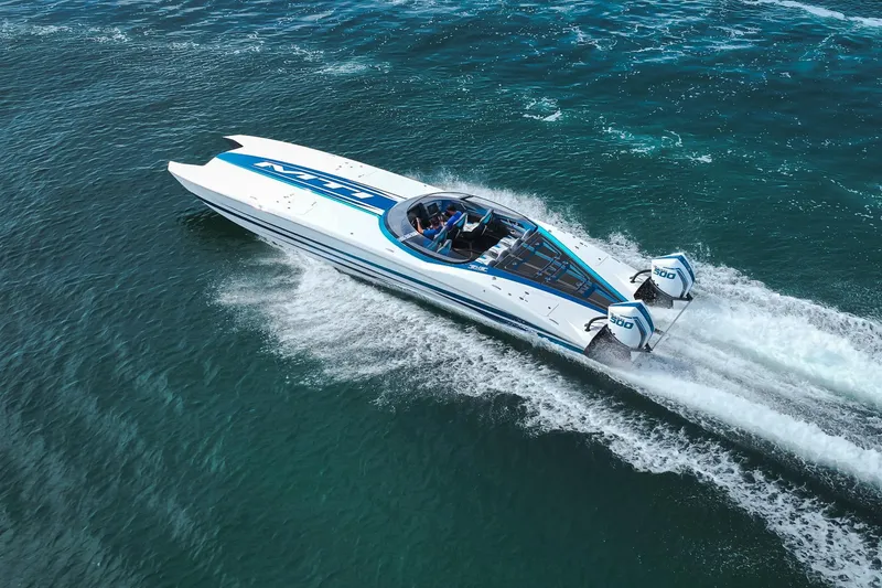  Yacht Photos Pics 2024 MTI 440X powerboat cruising on open water, showcasing sleek design and powerful engines.