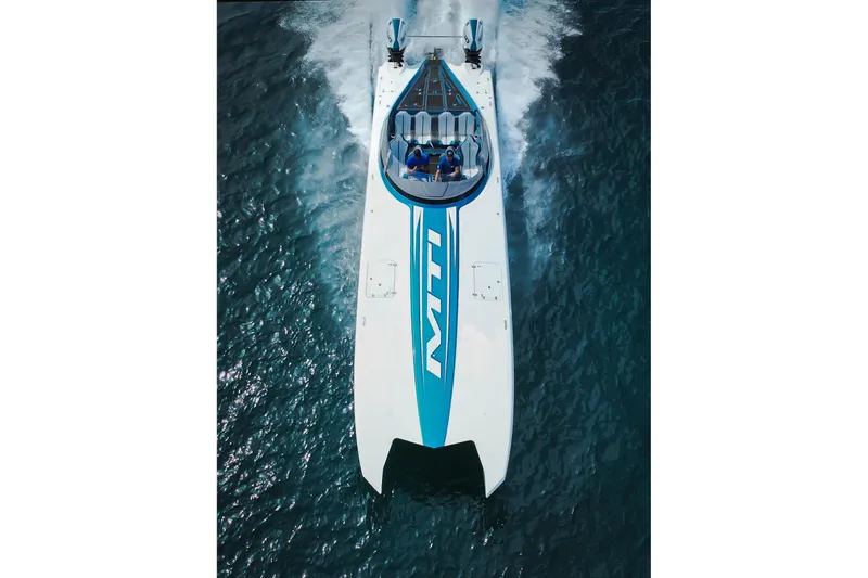  Yacht Photos Pics 2024 MTI 440X powerboat speeding on open water, aerial view.