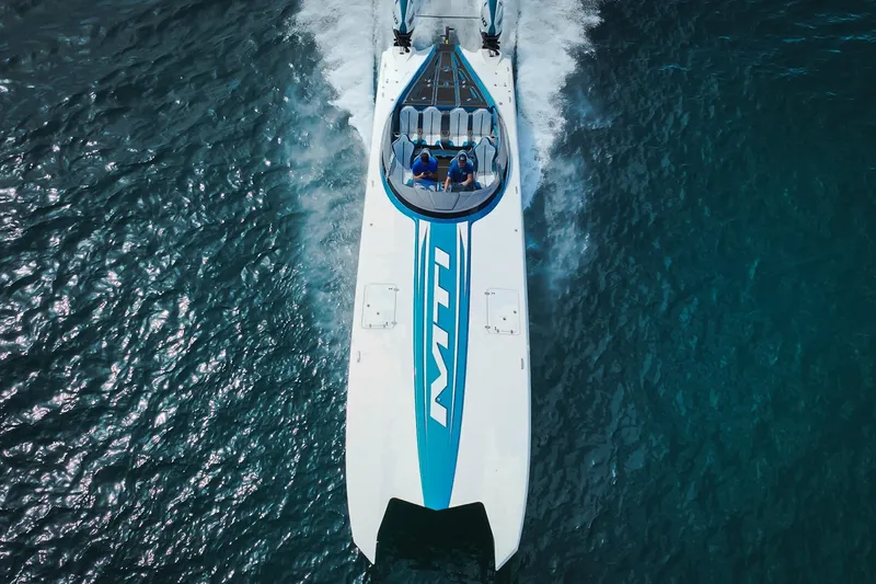  Yacht Photos Pics 2024 MTI 440X powerboat cruising on clear blue water, aerial view.