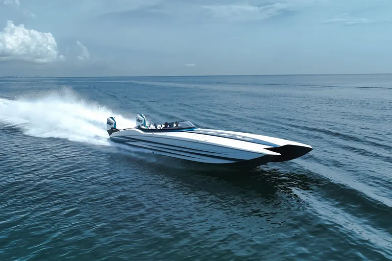  Yacht Photos Pics 2024 MTI 440X speedboat cruising on open water under a clear sky.