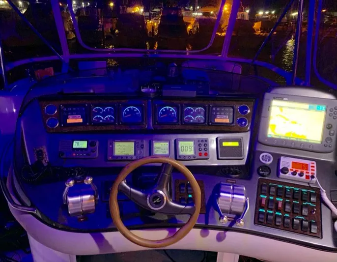  Yacht Photos Pics Control panel of a 2000 Sea Ray 480 Sedan Bridge yacht, illuminated at night.