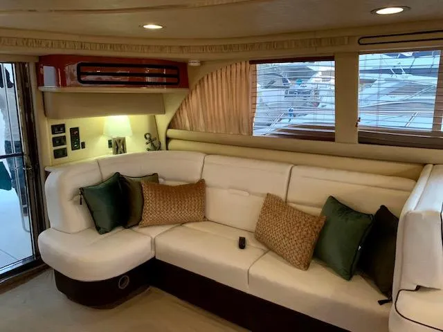  Yacht Photos Pics Luxurious interior of 2000 Sea Ray 480 Sedan Bridge yacht with plush seating and elegant decor.