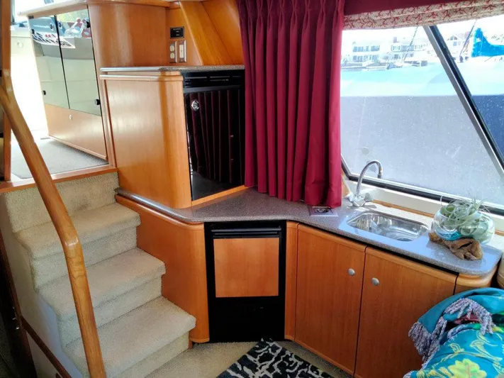 Coffey To Cocktails II Yacht Photos Pics Interior of 1998 Bayliner 4788 Motoryacht with kitchen and stairs.