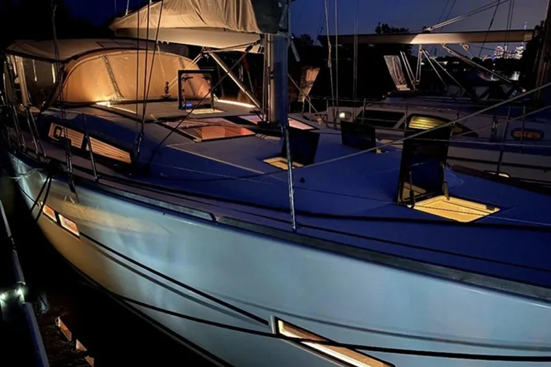  Yacht Photos Pics 2019 Dufour Grand Large 412 Grand Prix yacht illuminated at night in marina.
