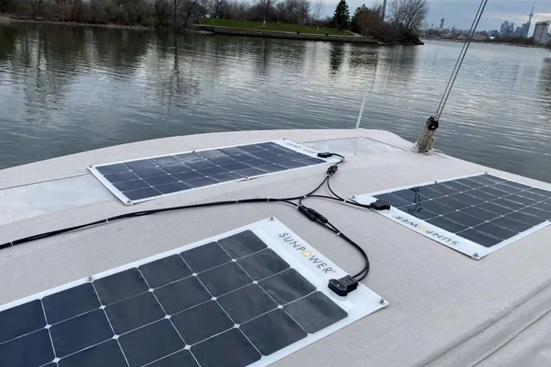  Yacht Photos Pics 2019 Dufour Grand Large 412 sailboat with solar panels on deck, near calm waters.