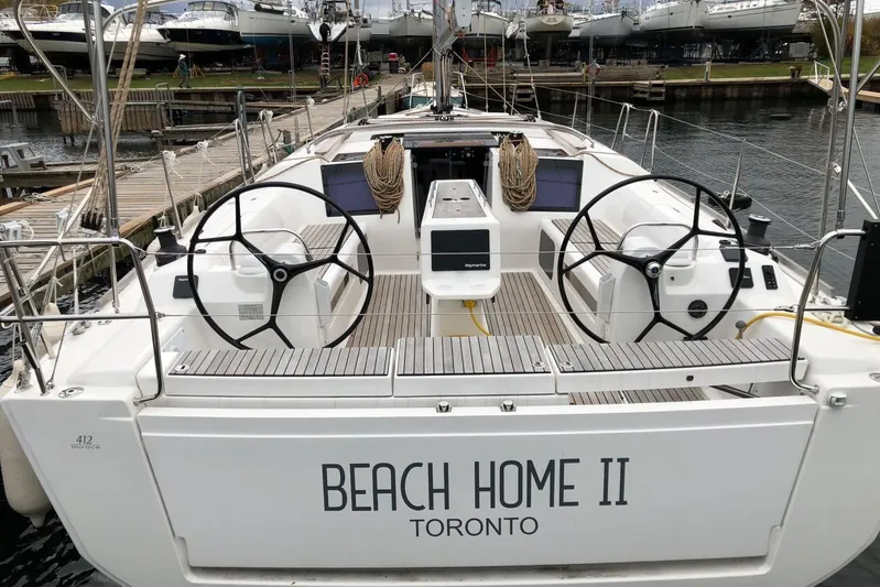  Yacht Photos Pics 2019 Dufour Grand Large 412 sailboat docked, dual steering wheels, "Beach Home II" nameplate.