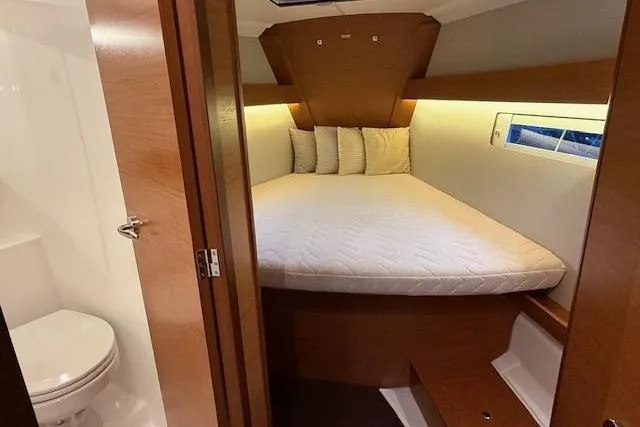  Yacht Photos Pics 2019 Dufour Grand Large 412 Grand Prix cabin with cozy bed and adjacent bathroom.