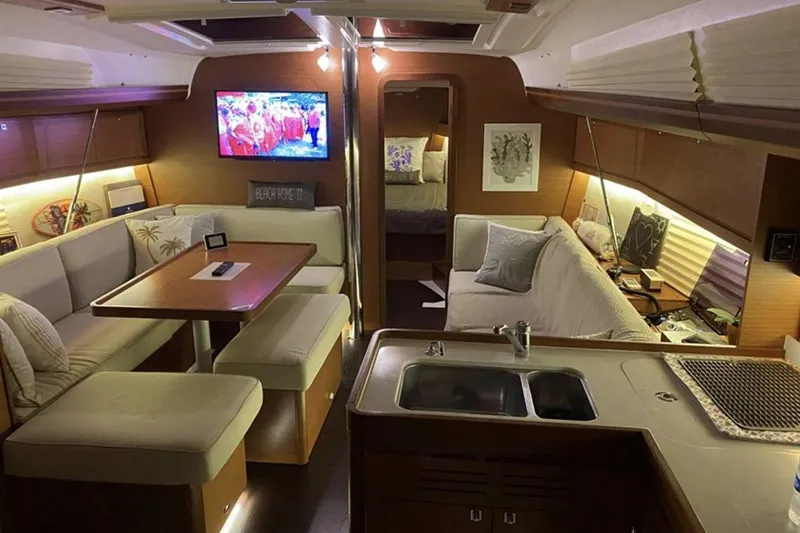  Yacht Photos Pics Luxurious interior of 2019 Dufour Grand Large 412 Grand Prix yacht with cozy seating and modern amenities.