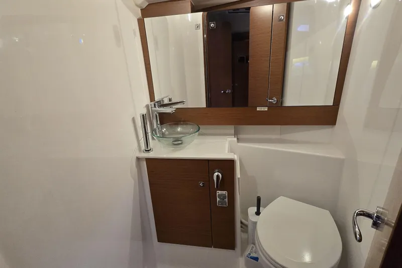  Yacht Photos Pics 2019 Dufour Grand Large 412 Grand Prix yacht bathroom with modern fixtures and wood accents.