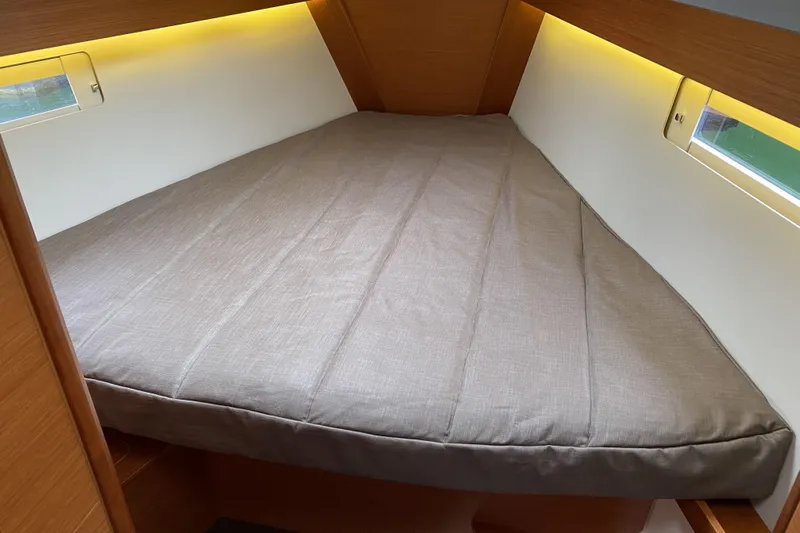  Yacht Photos Pics Interior cabin of 2019 Dufour Grand Large 412 Grand Prix yacht, featuring a cozy bed.