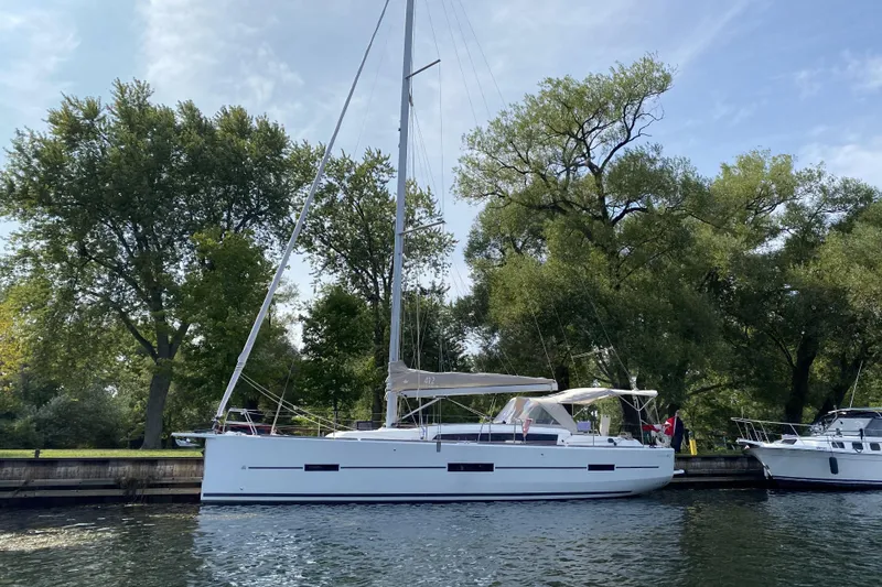  Yacht Photos Pics 2019 Dufour Grand Large 412 Grand Prix yacht docked by trees.