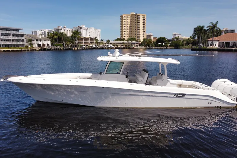  Yacht Photos Pics 2020 HCB 42 Siesta boat on calm water, urban skyline in background.