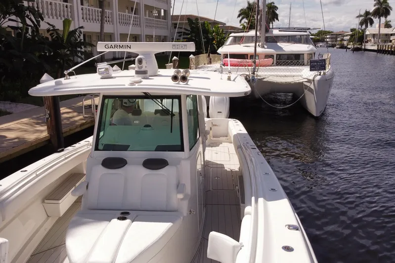  Yacht Photos Pics 2020 HCB 42 Siesta boat docked beside a catamaran in a sunny canal.