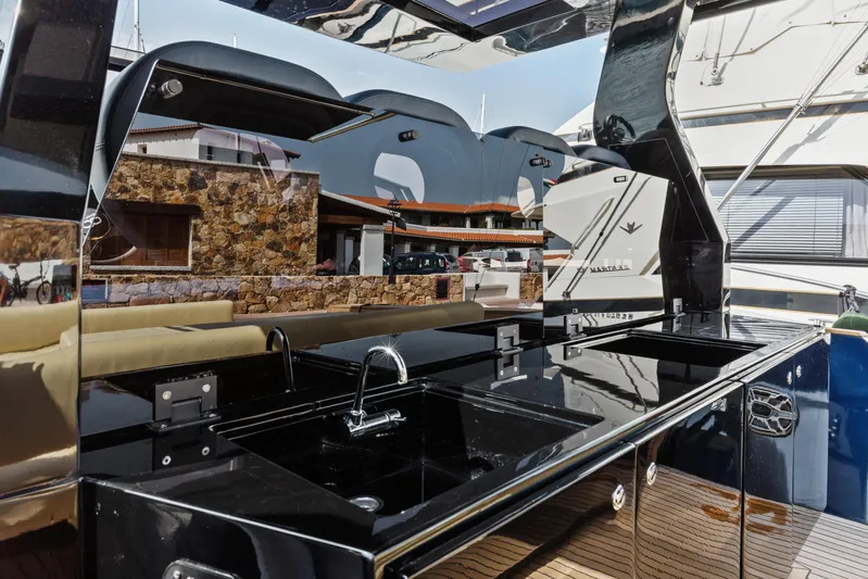  Yacht Photos Pics Luxurious Seanfinity T4 yacht kitchen area with sleek black countertops, 2021 model.