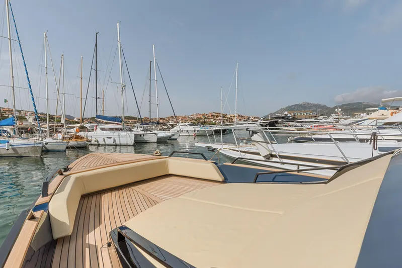  Yacht Photos Pics Seanfinity T4 2021 yacht docked in a marina with sailboats and hills in the background.