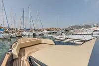 Seanfinity T4 2021 yacht docked in a marina with sailboats and hills in the background.