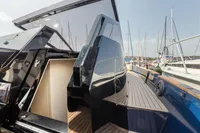 Seanfinity T4 2021 yacht with sleek design and wooden deck at marina.