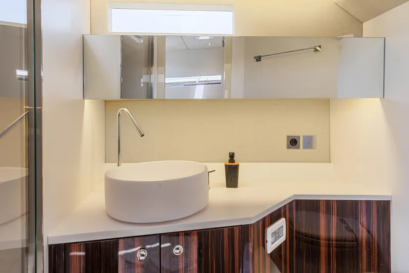  Yacht Photos Pics Modern bathroom interior in 2021 Seanfinity T4 yacht, featuring sleek sink and mirrored cabinets.