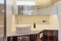 Modern bathroom interior in 2021 Seanfinity T4 yacht, featuring sleek sink and mirrored cabinets.